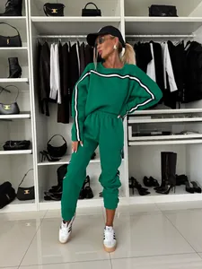 Stylish women's green two-piece tracksuit featuring a striped sweatshirt and matching joggers