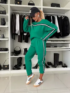 Fashionable green crewneck sweatshirt and joggers set with side stripes on a model