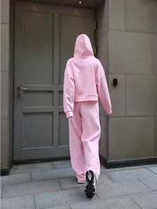 Back view showing fit of pink sports cotton set with hooded sweatshirt and wide-leg pants