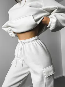 Detail of white two-piece sweatsuit with high-waisted cargo pants and cropped hoodie