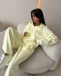 Women's pale yellow two-piece cotton tracksuit set with zip-up hoodie and wide-leg pants