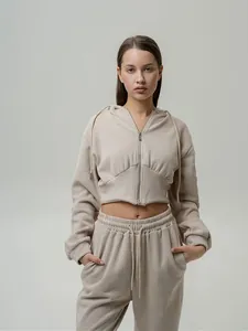 Detailed view of women's beige cropped zip-up hoodie and matching sweatpants set