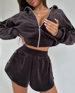 Detailed view of women's velvet two-piece set featuring zip-up cardigan and piping shorts.