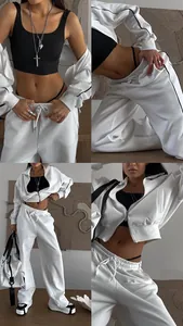 Vues détaillées d'un ensemble de survêtement blanc deux pièces avec veste zippée et pantalon.