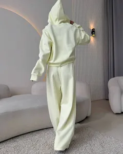Back view of a pale yellow cotton hooded tracksuit with wide-leg trousers for women