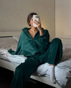 Emerald green velvet tracksuit set featuring a zip-up hoodie and matching sweatpants