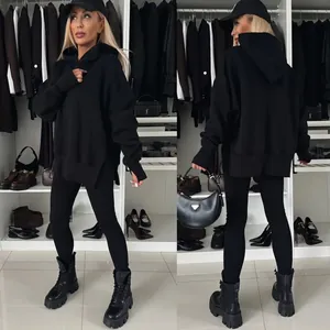Conjunto de sudadera con capucha oversize y leggings negros para mujer en un vestidor