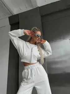 Detailed view of white women's cropped zip-up hoodie and drawstring sweatpants set