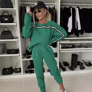 Women's green two-piece loungewear set with stripe detail crewneck sweatshirt and joggers