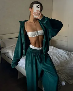 Stylish dark green velvet tracksuit set with zip-up hoodie and matching joggers for women