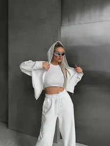 Lifestyle view of a model in a white 3-piece casual hoodie and wide-leg sweatpants set