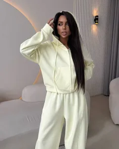 Elegant light yellow women's two-piece tracksuit featuring a zip-up hoodie and cotton pants