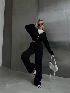 Full body view of a stylish black zip-up hoodie and matching wide-leg sweatpants set