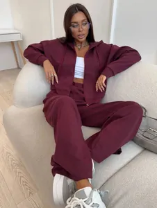 Detail view of women's burgundy two-piece tracksuit with zip hoodie and sweatpants