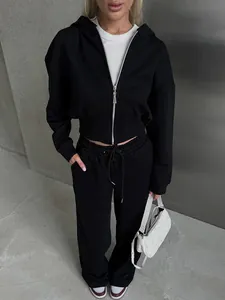 Detail of women's black two-piece tracksuit with zip-up hoodie and drawstring sweatpants