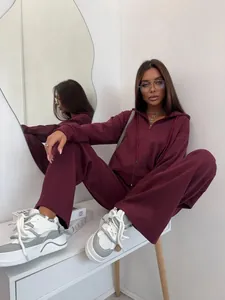 Detailed view of a stylish burgundy two-piece cotton tracksuit set on a lifestyle model.