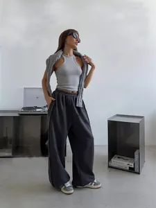 Model wearing American street style loose charcoal grey sweatpants and grey tank top