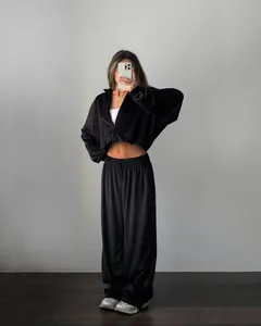 Casual black velvet two-piece set with cropped zip hoodie and wide-leg sweatpants