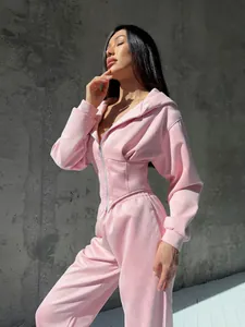 Vista dettagliata della tuta sportiva rosa in velluto con felpa e vita a corsetto