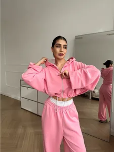 Women's pink two-piece tracksuit set with zip-up hoodie and matching sweatpants