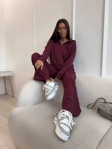 Model wearing a stylish burgundy zip-up hoodie and wide-leg pants cotton tracksuit on a sofa