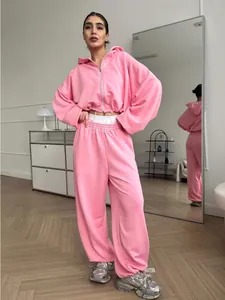 Full-length view of a pink 2-piece tracksuit with zip-up hoodie and drawstring joggers