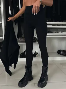 Detalle de los leggings negros de talle alto en un vestidor de lujo