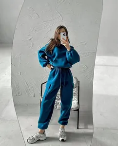 Stylish teal two-piece hoodie and cargo cargo sweatpants tracksuit set in a mirror selfie