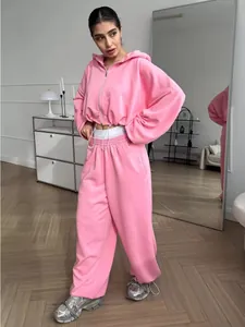 Full view of women's pink tracksuit featuring a cropped zip hoodie and wide-leg joggers