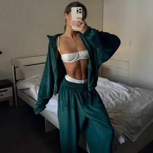 Women's emerald green velvet two-piece tracksuit with zip-up hoodie and loose sweatpants