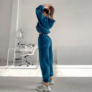 Back view of a stylish teal blue two-piece hoodie and cargo jogger tracksuit set