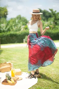 Close-up of woman in red mandala printed wrap maxi skirt at an outdoor picnic