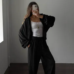 Chic women's two-piece black tracksuit set with zipper hoodie and wide-leg pants for loungewear