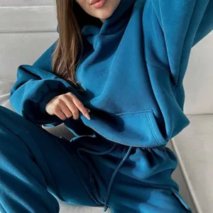 Close-up of a teal oversized hoodie set, showing soft fabric texture and pouch pocket.