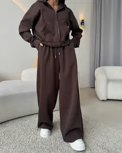 Detail of dark brown women's two-piece cotton tracksuit with zip-up hoodie and wide-leg pants.