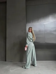 Stylish sage green women's tracksuit set with zip-up hoodie and wide-leg trousers