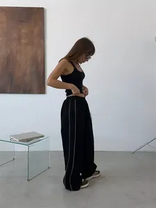 Street style black wide leg sweatpants with white side stripes and elastic waist
