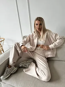 Casual beige women's tracksuit set featuring a zip-up hoodie and drawstring pants