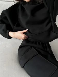 Close-up of black hoodie and cargo sweatpants set with soft fabric texture