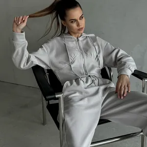 Two-piece grey tracksuit set with cropped zip-up hoodie and matching drawstring joggers