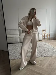 Stylish beige two-piece tracksuit set featuring a zip-up hoodie and wide-leg pants