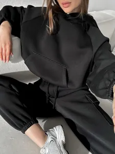 Detailed view of women black oversized hooded sweatshirt and matching joggers tracksuit set