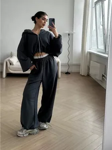 Women's black two-piece lounge set with cropped zip hoodie and wide-leg joggers
