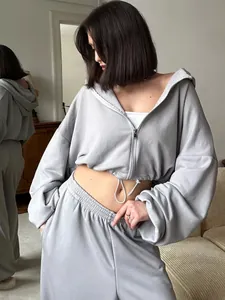 Close-up view of a grey two-piece lounge set with cropped zip-up hoodie and sweatpants