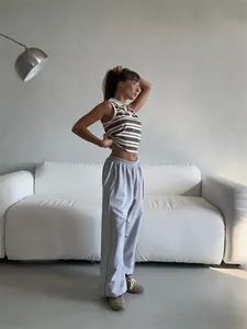 Full view of women's baggy grey sweatpants featuring an elastic waist and street style