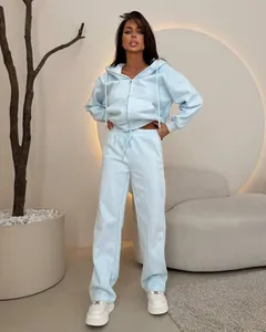 Detail of women's two-piece light blue sports set with zip-up hoodie and matching pants
