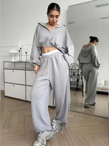 Detailed view of a grey two-piece casual tracksuit set with a zip-up hoodie and sweatpants.