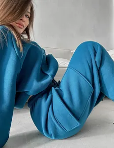 Close-up of cozy teal blue women's oversized sweatsuit with cargo pocket details