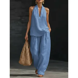 Stylish women's light blue sleeveless linen halter top and wide-leg trousers set
