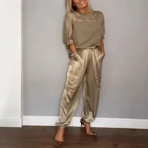 Elegant two-piece satin lounge set featuring a short-sleeved top and cargo pants in champagne